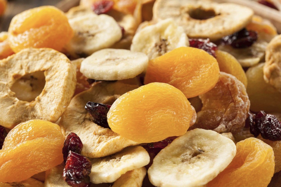 A healthy mix of nutrient-rich dried fruits including apricots, bananas, and cranberries
