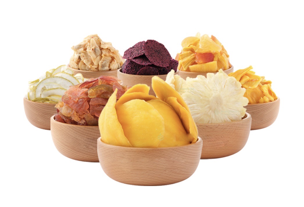 An assortment of different types of dry fruits displayed in wooden bowls including dried mango, dragon fruit, and pineapple
